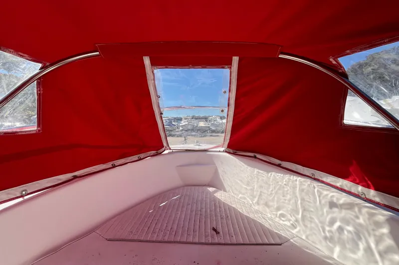 Slide: The Image of Interior view of a 2001 Boston Whaler 16 Dauntless with red canopy. - 5