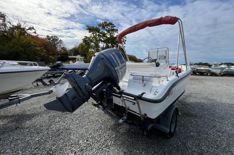 Slide: The Image of 2001 Boston Whaler 16 Dauntless boat with Yamaha outboard motor on gravel lot. - 9