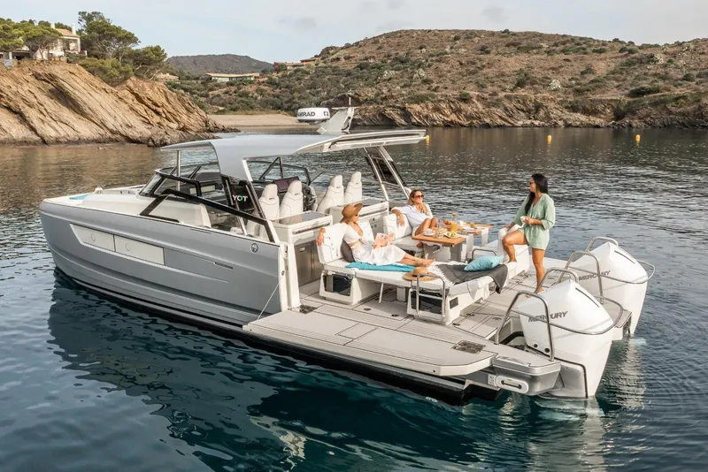 Slide: The Image of Luxury YOT 36 boat, 2026 model, with people relaxing on deck in scenic coastal waters. - 10