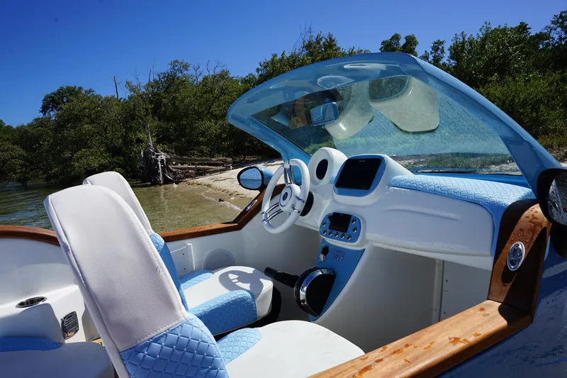 Slide: The Image of Interior of 2025 Car Off-shore Fiat 500 Classic boat with blue and white seats. - 8