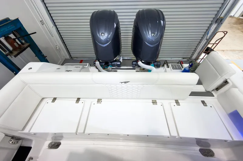 Slide: The Image of 2026 Tidewater 256 LXF boat with dual engines in a garage setting. - 10