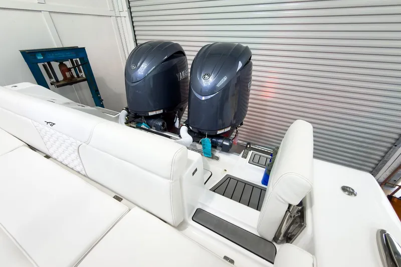 Slide: The Image of 2026 Tidewater 256 LXF boat with dual Yamaha outboard engines in a garage setting. - 12
