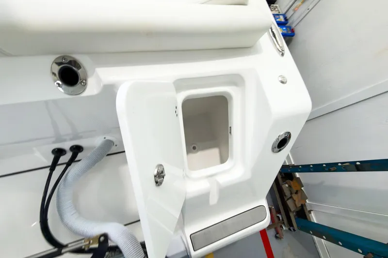 Slide: The Image of Interior view of 2026 Tidewater 256 LXF boat, white storage compartment. - 15
