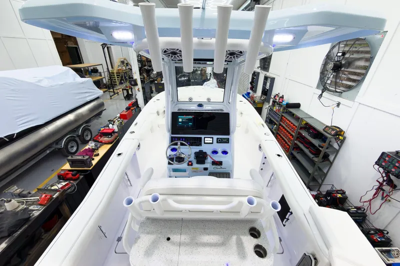 Slide: The Image of 2026 Tidewater 256 LXF boat interior in a workshop, showcasing advanced controls and seating. - 16
