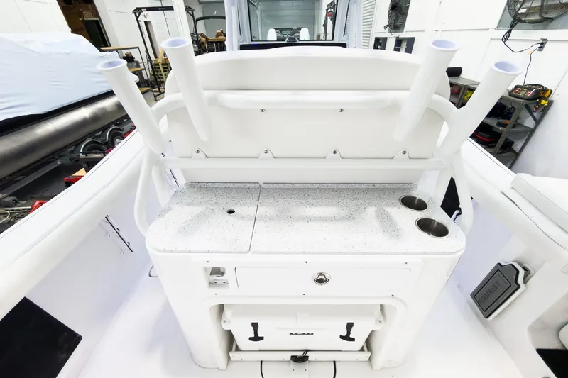 Slide: The Image of 2026 Tidewater 256 LXF boat interior with rod holders and storage compartments. - 17