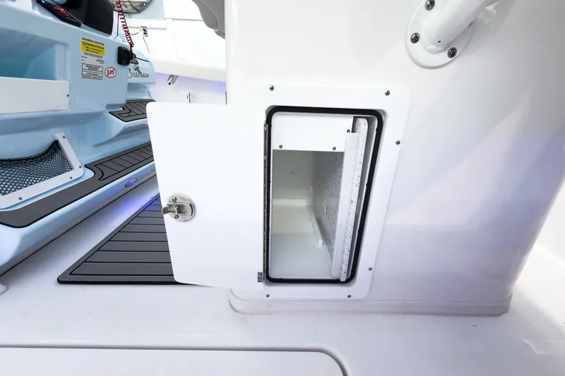 Slide: The Image of 2026 Tidewater 256 LXF boat storage compartment with open door, showcasing interior space. - 19