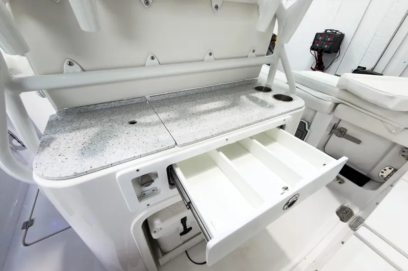 Slide: The Image of 2026 Tidewater 256 LXF boat interior with storage drawers and cup holders. - 20