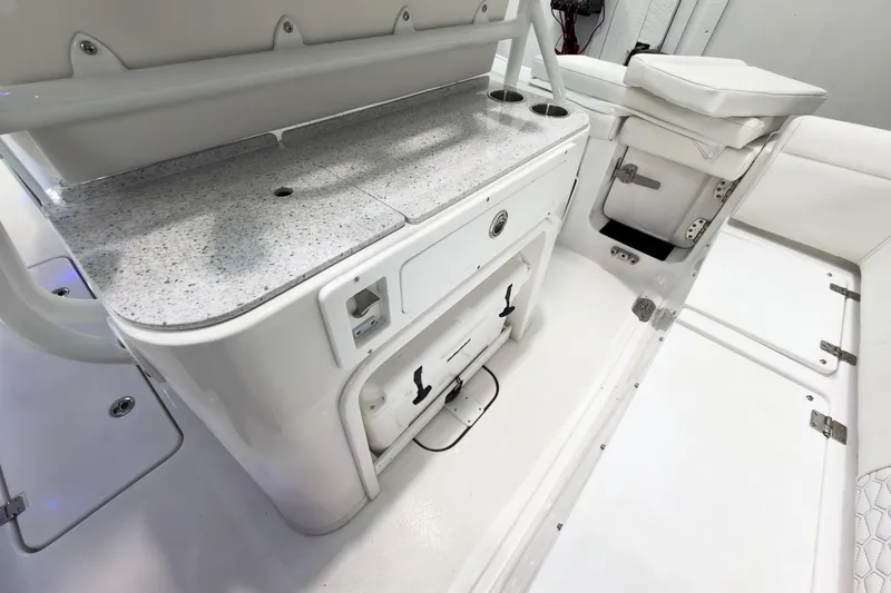 Slide: The Image of 2026 Tidewater 256 LXF boat interior with sleek white seating and storage compartments. - 21