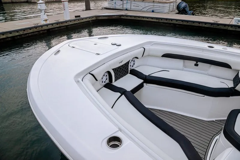 Slide: The Image of 2026 Tidewater 256 LXF boat with dual Yamaha 150 outboard engines in a modern garage. - 3