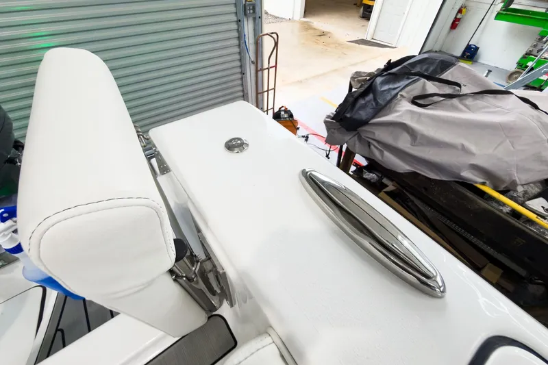 Slide: The Image of 2026 Tidewater 256 LXF boat interior with white seating and stainless steel details. - 30