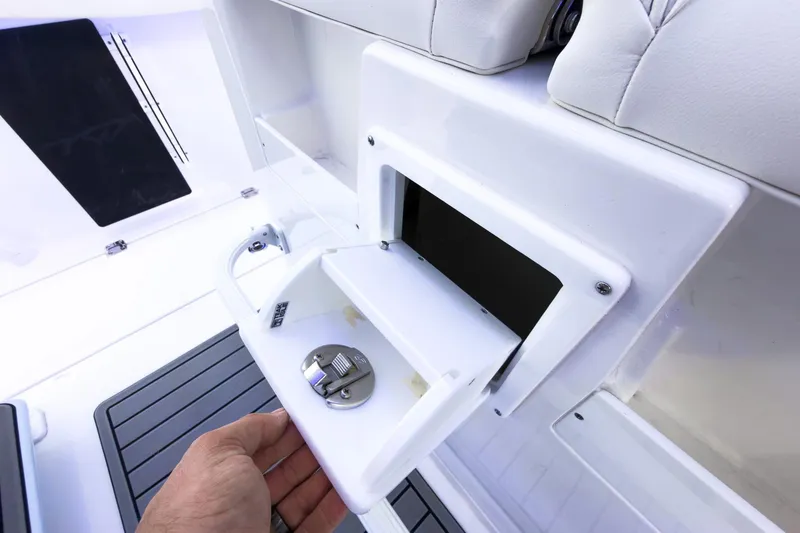 Slide: The Image of 2026 Tidewater 256 LXF boat storage compartment with white interior and sleek design. - 33