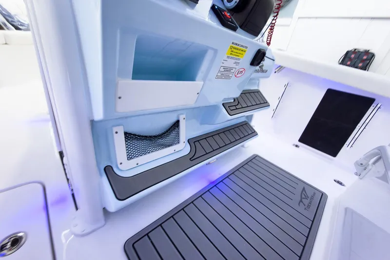 Slide: The Image of 2026 Tidewater 256 LXF boat interior with storage compartments and non-slip flooring. - 36