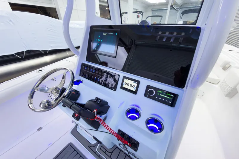 Slide: The Image of 2026 Tidewater 256 LXF boat dashboard with modern controls and steering wheel. - 37