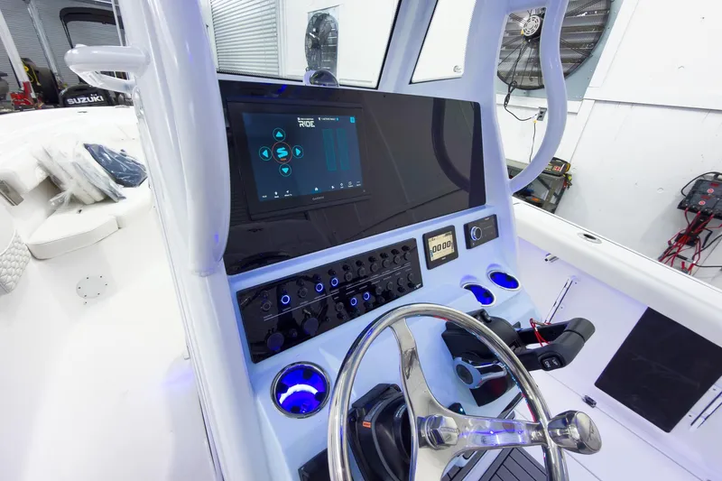 Slide: The Image of Helm of 2026 Tidewater 256 LXF boat with modern controls and touchscreen display. - 38