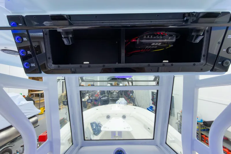 Slide: The Image of 2026 Tidewater 256 LXF boat console with electronic controls and storage compartment. - 40