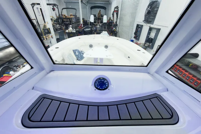 Slide: The Image of Interior view of 2026 Tidewater 256 LXF boat in a workshop setting. - 41