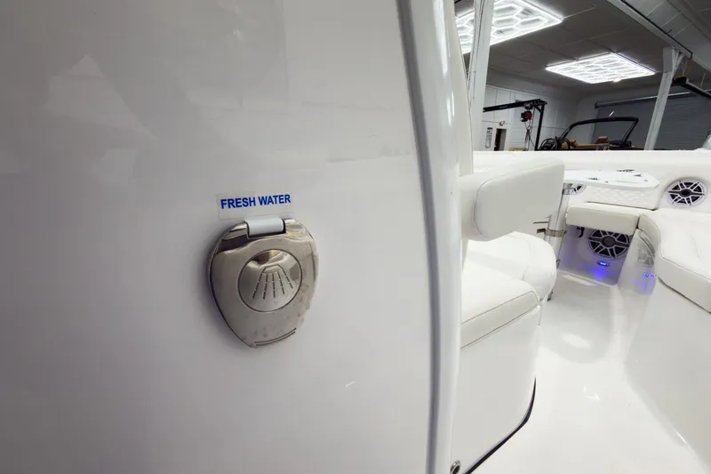 Slide: The Image of 2026 Tidewater 256 LXF boat interior with fresh water access and modern seating. - 46