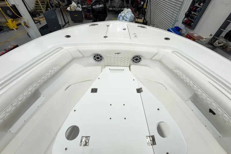 Slide: The Image of 2026 Tidewater 256 LXF boat interior with white seating and storage compartments. - 52