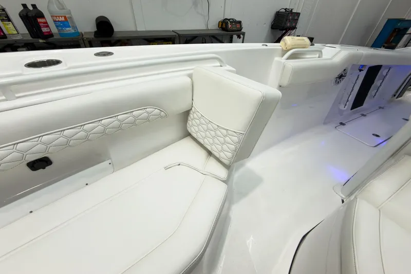 Slide: The Image of 2026 Tidewater 256 LXF boat interior with white cushioned seating and modern design. - 53