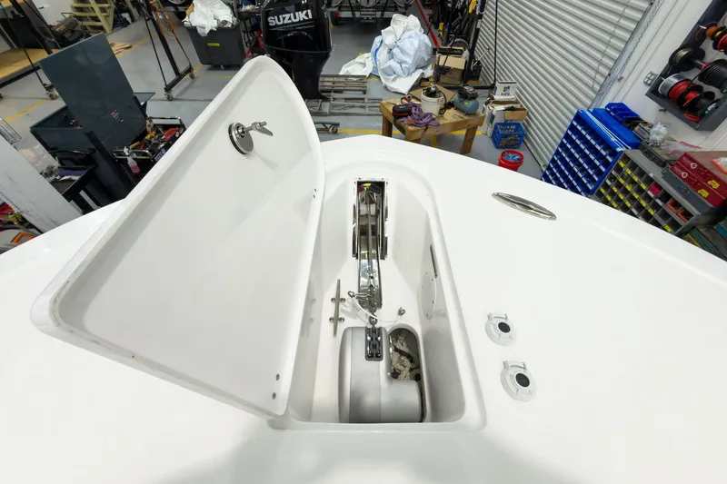 Slide: The Image of Open anchor compartment on 2026 Tidewater 256 LXF boat in a workshop setting. - 57