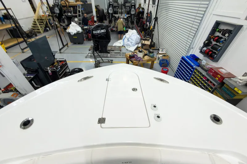 Slide: The Image of 2026 Tidewater 256 LXF boat in workshop with Suzuki outboard motors. - 58