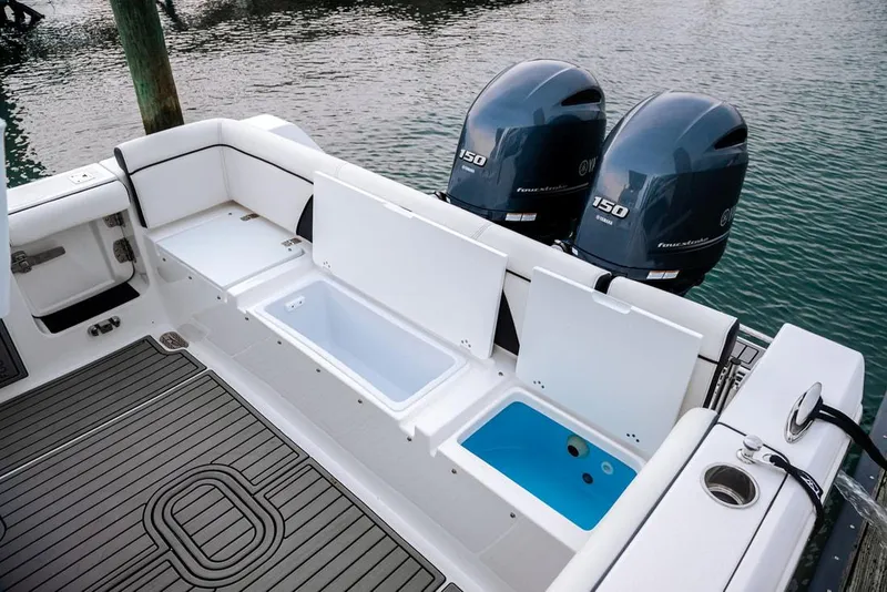 Slide: The Image of 2026 Tidewater 256 LXF boat on trailer in a modern showroom. - 6