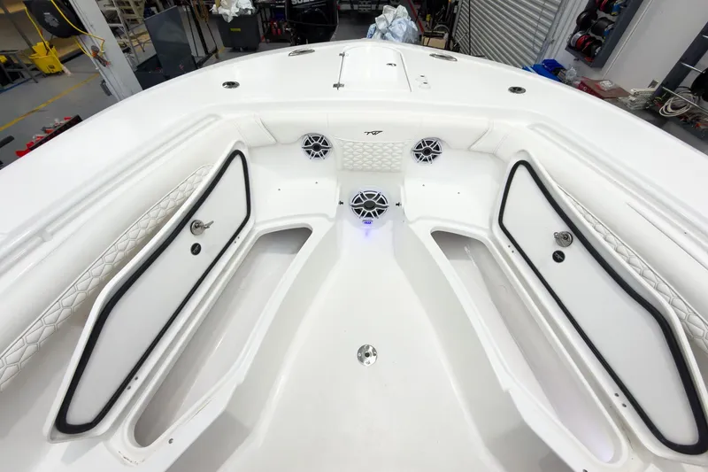 Slide: The Image of 2026 Tidewater 256 LXF boat interior with storage compartments and speakers. - 60