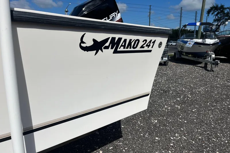 Slide: The Image of 1995 Mako 248 boat with "Mako 241" decal, parked on gravel lot. - 11