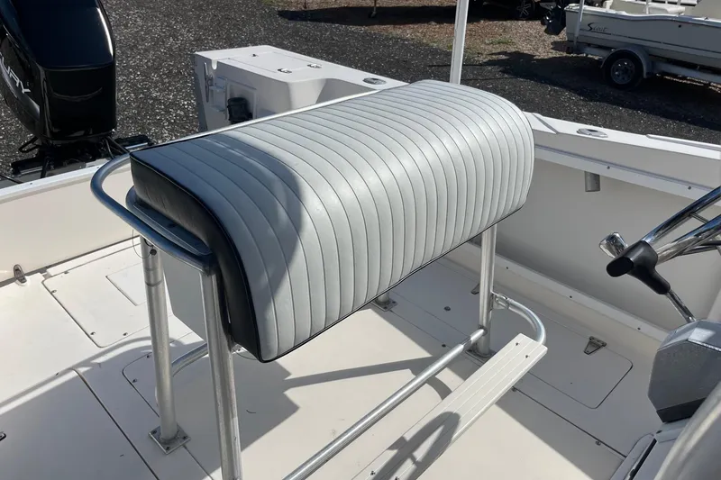 Slide: The Image of 1995 Mako 248 boat interior with cushioned seating and steering wheel. - 7