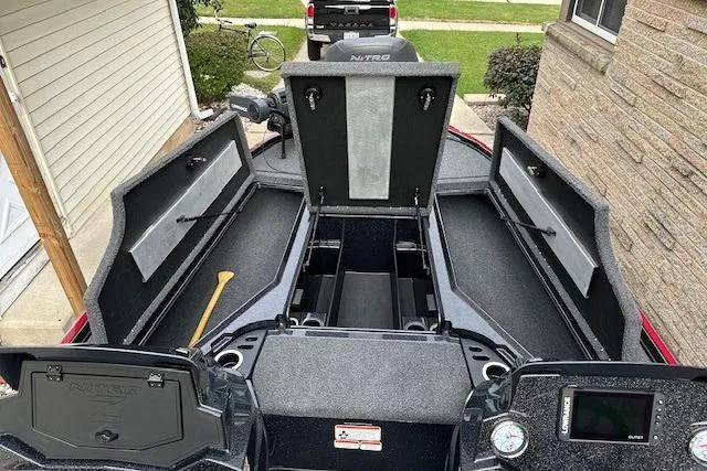 Slide: The Image of 2023 Nitro Z18 Pro boat with open storage compartments, parked in a driveway. - 11