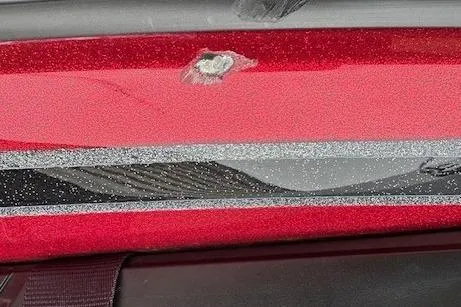 Slide: The Image of Close-up of a red 2023 Nitro Z18 Pro boat with visible paint damage. - 12