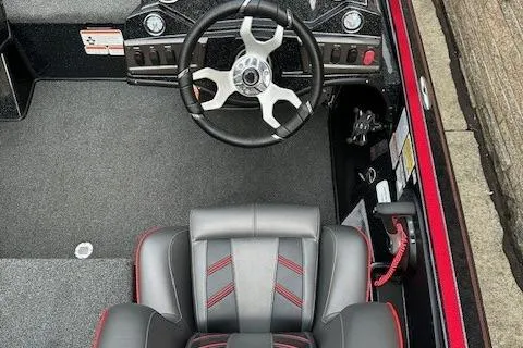 Slide: The Image of 2023 Nitro Z18 Pro boat interior with steering wheel and seat, featuring sleek design and controls. - 13