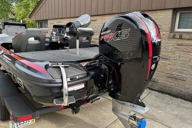 Slide: The Image of 2023 Nitro Z18 Pro boat with Mercury Pro XS engine, parked on a driveway. - 3