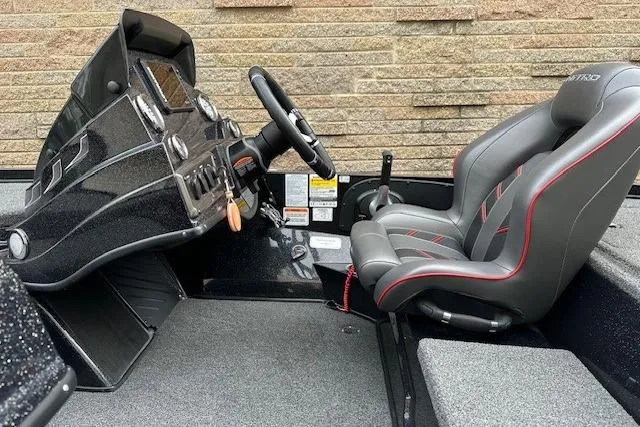 Slide: The Image of 2023 Nitro Z18 Pro boat interior with steering wheel and cushioned seat. - 6