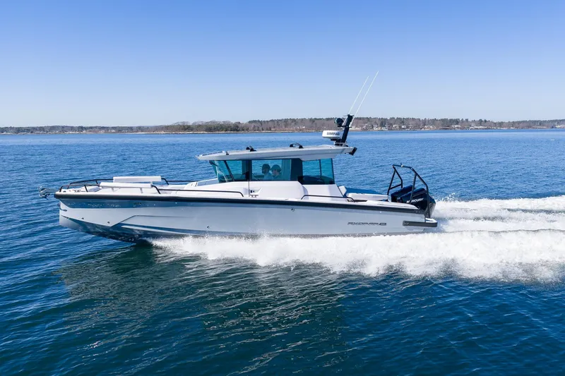 The Image of 2026 Axopar 29 XC Cross Cabin yacht cruising on blue ocean waters. - 0