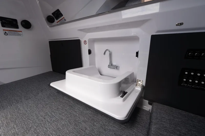 Slide: The Image of Interior view of 2026 Axopar 29 Cross Cabin with compact sink and modern design. - 20