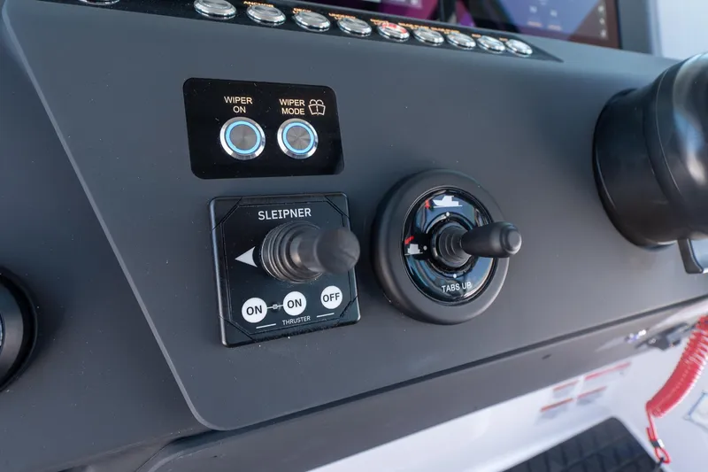 Slide: The Image of Control panel of 2026 Axopar 29 Cross Cabin boat with wiper and thruster switches. - 35