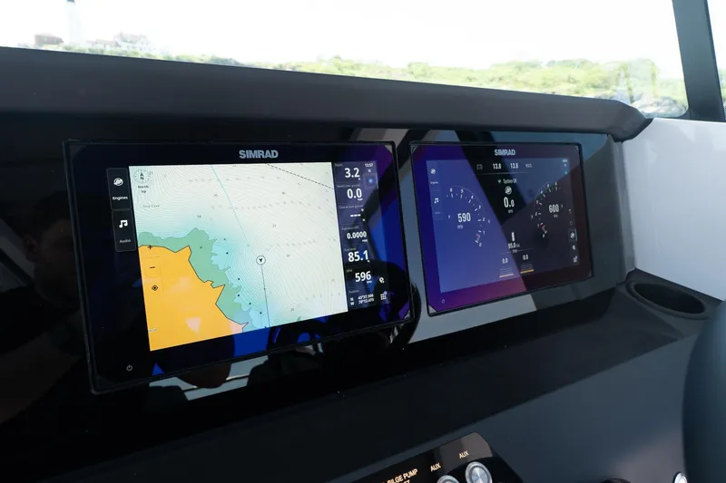 Slide: The Image of Simrad navigation screens on 2026 Axopar 29 Cross Cabin boat dashboard. - 36