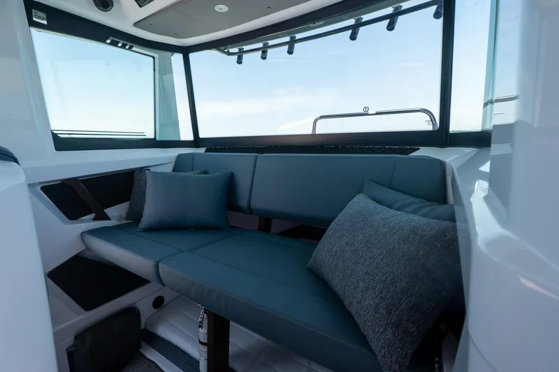 Slide: The Image of Luxurious interior of 2026 Axopar 29 Cross Cabin with plush seating and cushions. - 39