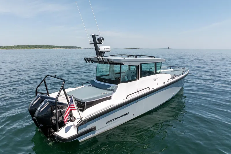Slide: The Image of 2026 Axopar 29 Cross Cabin boat on calm sea with clear sky. - 9
