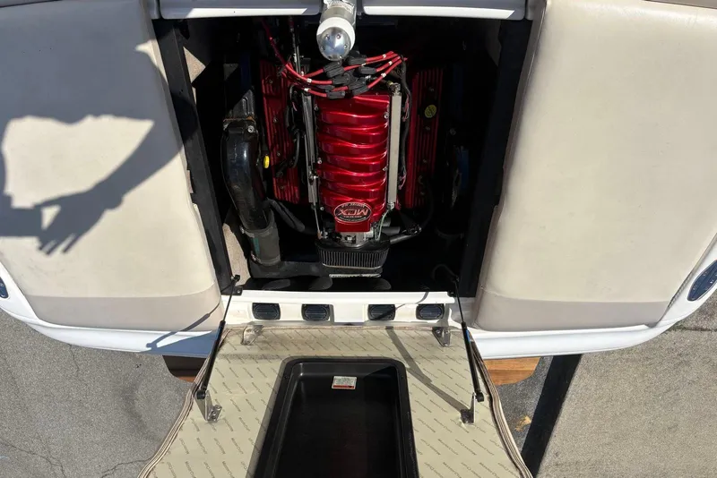 Slide: The Image of 2003 MasterCraft MariStar 230 SV engine compartment with red engine cover. - 13