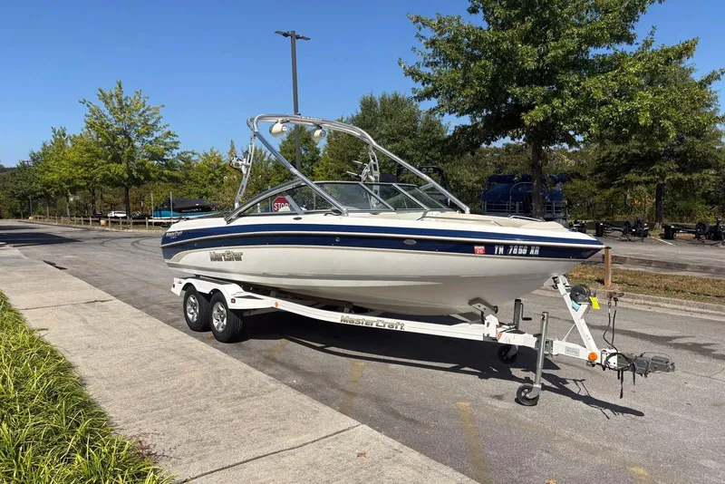 Slide: The Image of 2003 MasterCraft MariStar 230 SV boat on trailer, parked outdoors on a sunny day. - 3
