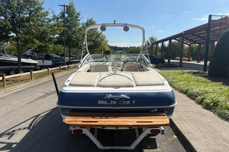 Slide: The Image of 2003 MasterCraft MariStar 230 SV boat parked outdoors on a sunny day. - 4