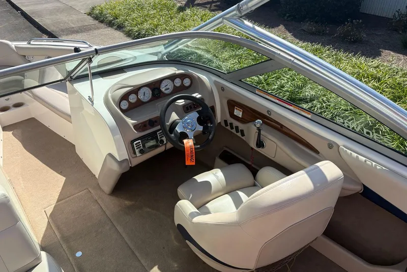 Slide: The Image of 2003 MasterCraft MariStar 230 SV boat interior with steering wheel and dashboard controls. - 6