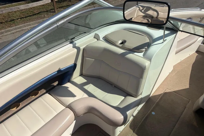 Slide: The Image of 2003 MasterCraft MariStar 230 SV boat interior with beige seating and cup holders. - 8