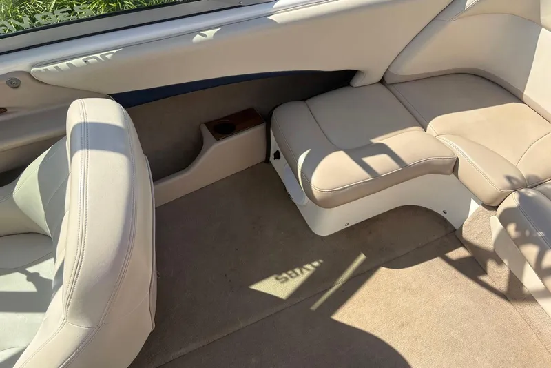 Slide: The Image of 2003 MasterCraft MariStar 230 SV interior with beige leather seats and carpeted flooring. - 9