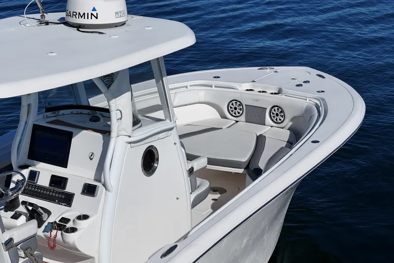 Slide: The Image of 2018 Tidewater 280 CC Adventure boat with modern helm and seating on calm water. - 11