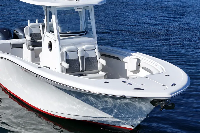 Slide: The Image of 2018 Tidewater 280 CC Adventure boat on calm blue water. - 15