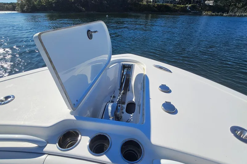 Slide: The Image of 2018 Tidewater 280 CC Adventure boat with open anchor hatch on calm water. - 17