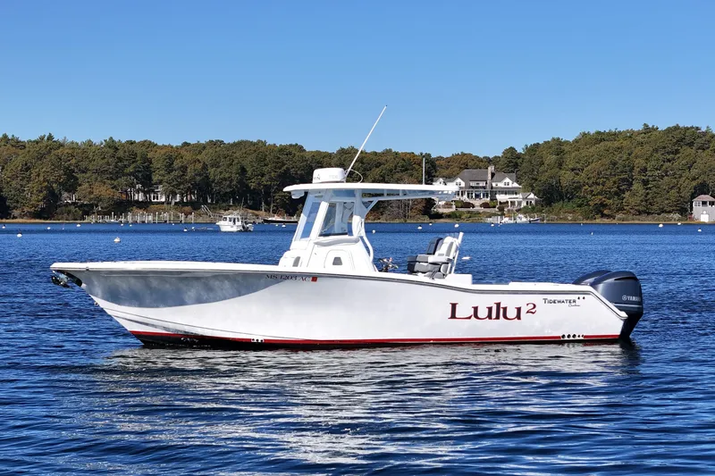 Slide: The Image of 2018 Tidewater 280 CC Adventure boat on calm blue water. - 2